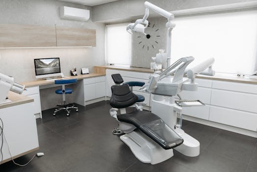 A modern dental clinic interior featuring a dental chair and equipment with a minimalist design.